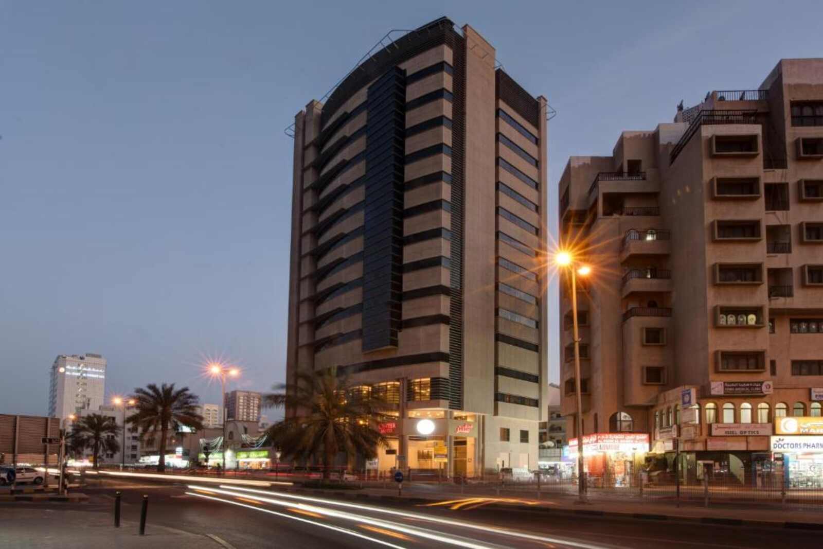 Center Hotel Sharjah tower in central Sharjah at dusk