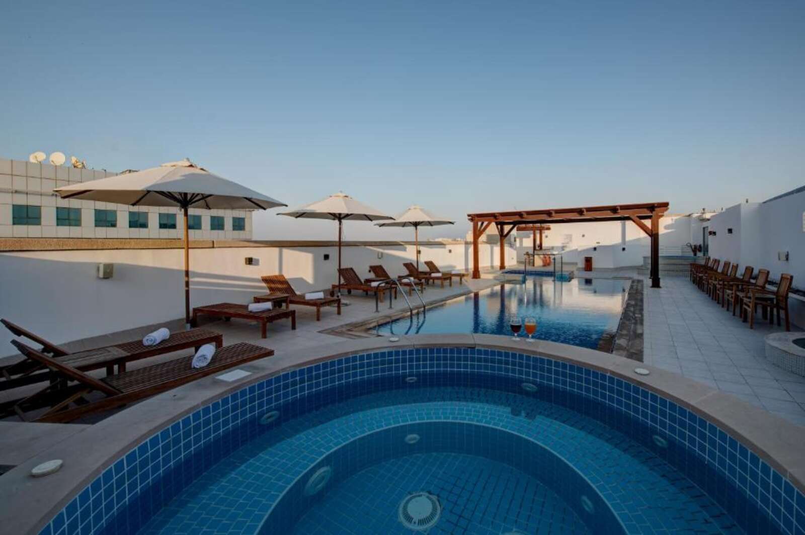 Rooftop outdoor swimming pool with loungers and umbrellas
